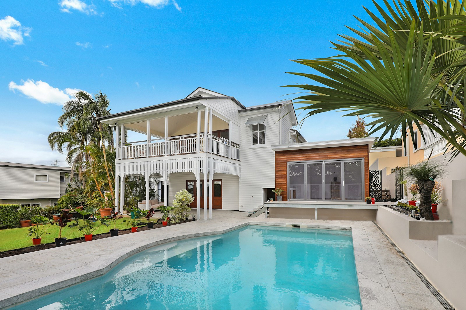 Photograph of a landscaped residential property with a swimming pool