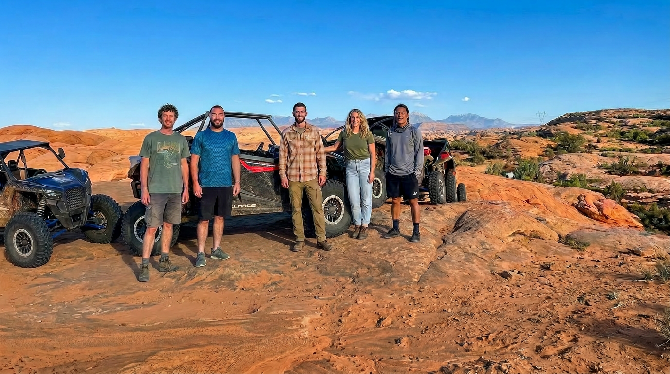 Group of friends with off-road buggies at sunset in Moab